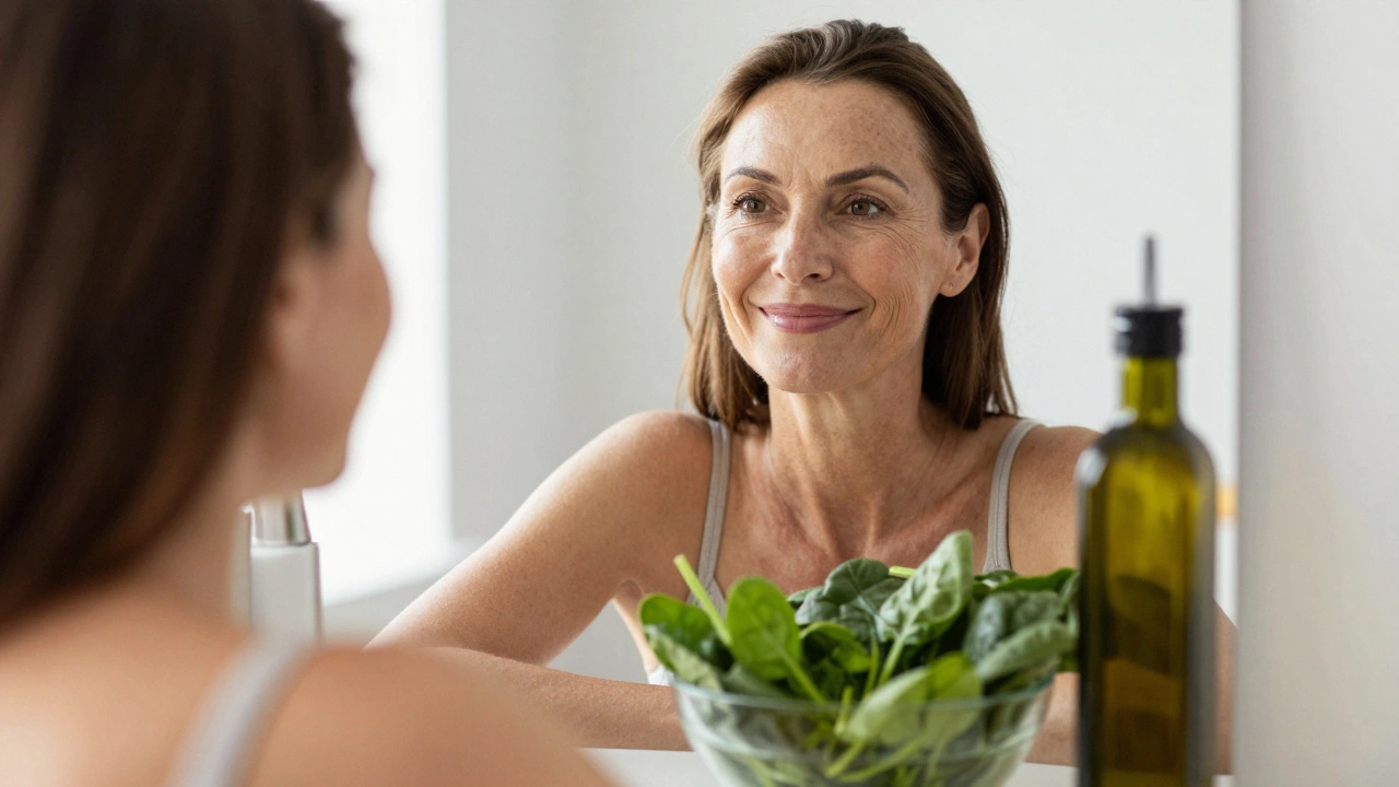 Woman smiling in front of a mirror with spinach and smoothie nearby